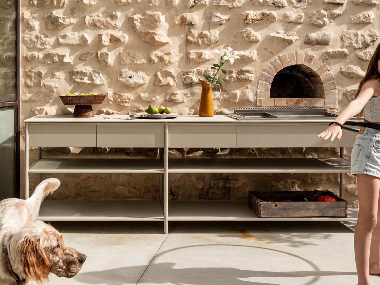 CSL frame unit with pizza oven in a rustic courtyard