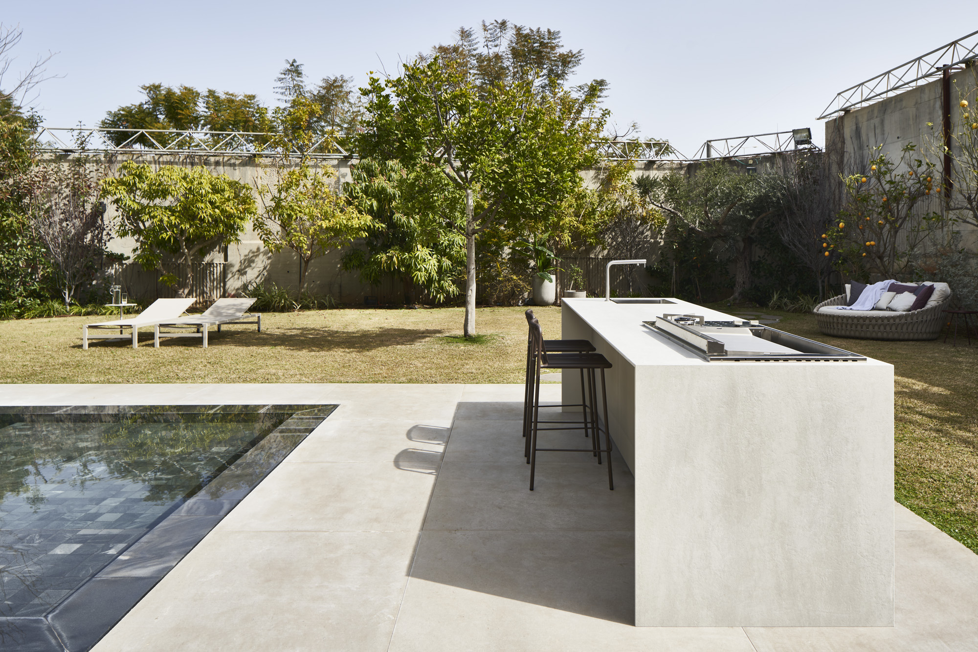 UNICA outdoor kitchen island beside a pool